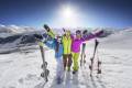 Young colorfull friends on ski alpine mountain winter resort